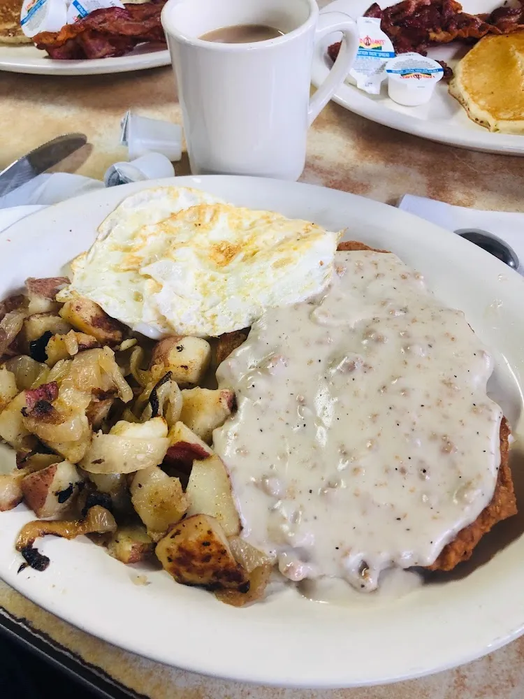 Country Fried Steak with Home Fries and an Egg over Medium